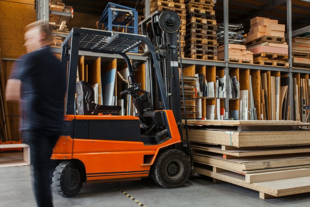 Man next to forklift