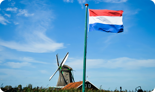 Dutch flag waving next to windmill