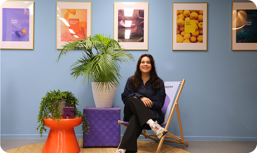 Team member seated in a welcoming office environment, reflecting an approachable brand and personal support during pricing decisions.