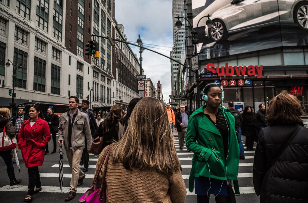Woman walking on the street seeing coming across lots of different people