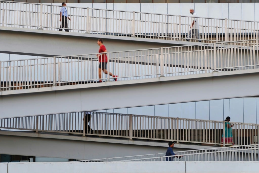 People walking and running on an accessible ramp