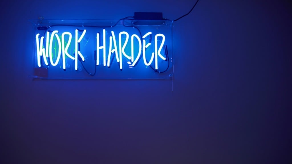 Neon sign "work harder"